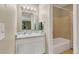 Bright bathroom with a single sink vanity and a shower-tub combo behind it at 387 Upham St, Lakewood, CO 80226