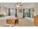 Bright bedroom with a ceiling fan, and a sliding glass door to a balcony with views of the outside at 387 Upham St, Lakewood, CO 80226