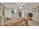 Relaxing bedroom featuring a ceiling fan, carpeted floors, and view of the bathroom at 387 Upham St, Lakewood, CO 80226