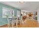Bright dining area with a round table, four chairs, and large window offering ample natural light at 387 Upham St, Lakewood, CO 80226