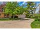 Charming exterior of a brick home with a well-manicured lawn and a spacious driveway leading to an attached garage at 387 Upham St, Lakewood, CO 80226