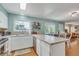 Open kitchen area with stainless steel dishwasher, wood floors, and natural light at 387 Upham St, Lakewood, CO 80226