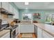 Well-lit kitchen featuring stainless steel appliances, ample countertop space, and modern backsplash at 387 Upham St, Lakewood, CO 80226