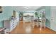 Modern kitchen featuring stainless steel appliances, white cabinetry, and an adjacent dining area at 387 Upham St, Lakewood, CO 80226