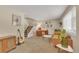 Spacious living room area with staircase, guitar, artwork, and comfortable seating at 387 Upham St, Lakewood, CO 80226