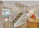 Carpeted staircase with white railings, connecting to an open layout with a desk and lamp at 387 Upham St, Lakewood, CO 80226