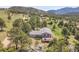 Aerial view of home with expansive land, trees, deck, and beautiful mountain views at 258 Post Boy Rd, Boulder, CO 80302