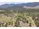 Expansive aerial view of a mountain community surrounded by lush green forests and rolling hills at 258 Post Boy Rd, Boulder, CO 80302