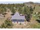 Aerial view of home with expansive land, trees, and deck with outdoor furniture at 258 Post Boy Rd, Boulder, CO 80302