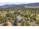 Aerial view of home with expansive land and trees and beautiful mountain views at 258 Post Boy Rd, Boulder, CO 80302