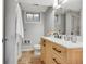 Bathroom featuring a wood vanity, marble countertop, and updated fixtures at 258 Post Boy Rd, Boulder, CO 80302