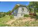 Exterior view of a gray home with multiple decks, bay window, and mature landscaping at 258 Post Boy Rd, Boulder, CO 80302