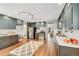 Well-lit kitchen with wood floors, stainless steel appliances, and painted wood cabinets at 258 Post Boy Rd, Boulder, CO 80302