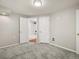 Bright basement space featuring neutral-colored walls, plush carpet, and access to a renovated full bathroom at 4111 W Kenyon Ave, Denver, CO 80236