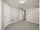 Versatile basement room with neutral walls, carpet, and two entry doors for flexible living or storage at 4111 W Kenyon Ave, Denver, CO 80236