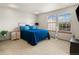 Bright bedroom showcasing a queen-sized bed, natural light, and cozy carpet at 4111 W Kenyon Ave, Denver, CO 80236