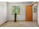 Bedroom featuring natural light from a window, a door, and carpeted floor at 4111 W Kenyon Ave, Denver, CO 80236