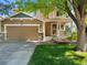 Charming two-story home with a covered front porch, two-car garage, and a well-maintained lawn at 4111 W Kenyon Ave, Denver, CO 80236