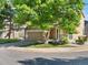 Charming home exterior features mature landscaping, a large shade tree, and attached two car garage at 4111 W Kenyon Ave, Denver, CO 80236