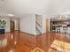 Open floor plan featuring wood floors and stairs leading to the upper level, adjoins kitchen at 4111 W Kenyon Ave, Denver, CO 80236
