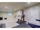 Finished basement featuring exercise equipment and a stairwell at 7099 E 123Rd Pl, Thornton, CO 80602