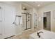 Bathroom with modern tiled shower with a glass door, white walls, and a large soaking tub at 7099 E 123Rd Pl, Thornton, CO 80602