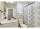 Bathroom with a decorative shower curtain, sink, vanity, and a linen closet at 7099 E 123Rd Pl, Thornton, CO 80602