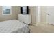 Bright bedroom featuring a dresser with a television and an attached bathroom at 7099 E 123Rd Pl, Thornton, CO 80602