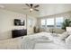 Bright bedroom featuring neutral tones, large windows, and an ensuite bathroom at 7099 E 123Rd Pl, Thornton, CO 80602