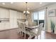Cozy dining space adjacent to the kitchen featuring hardwood floors and sliding glass doors to the exterior at 7099 E 123Rd Pl, Thornton, CO 80602