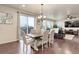 Open dining area featuring hardwood floors and a sliding glass door providing natural light at 7099 E 123Rd Pl, Thornton, CO 80602
