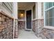 Welcoming entryway with stone accents, providing a stylish and inviting first impression at 7099 E 123Rd Pl, Thornton, CO 80602
