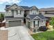 Charming two-story home with stone accents, a well-manicured lawn and a three car garage at 7099 E 123Rd Pl, Thornton, CO 80602