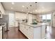 Stylish kitchen with large island, granite countertops, stainless appliances, and ample cabinet space at 7099 E 123Rd Pl, Thornton, CO 80602
