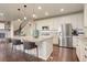 Bright kitchen with a large center island, stainless appliances, and hardwood floors at 7099 E 123Rd Pl, Thornton, CO 80602