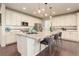 Bright kitchen with a large center island, stainless appliances, pendant lighting and hardwood floors at 7099 E 123Rd Pl, Thornton, CO 80602