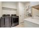 Functional laundry room featuring modern washer and dryer appliances at 7099 E 123Rd Pl, Thornton, CO 80602