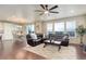Spacious living room with hardwood floors, lots of natural light, comfortable seating, and an open layout at 7099 E 123Rd Pl, Thornton, CO 80602