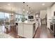 Open concept living space showing kitchen, dining, fireplace, and staircase at 7099 E 123Rd Pl, Thornton, CO 80602