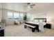Serene main bedroom with ample natural light, a ceiling fan, and neutral decor, creating a peaceful retreat at 7099 E 123Rd Pl, Thornton, CO 80602