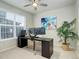 Well-lit office with a large desk setup, perfect for a home office, with a ceiling fan and artwork at 7099 E 123Rd Pl, Thornton, CO 80602