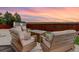 Inviting patio with stylish outdoor seating and a fire pit, perfect for enjoying the sunset at 7099 E 123Rd Pl, Thornton, CO 80602