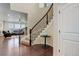 Elegant staircase with dark wood railing, carpeted steps, and open to the living area at 7099 E 123Rd Pl, Thornton, CO 80602