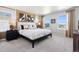 Bright bedroom featuring a king bed, carpeted floors, and views of neighborhood at 1380 S Boston Ct # A, Denver, CO 80247