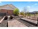 Landscaped backyard featuring raised garden beds, mulch and partial fencing at 27290 E Nova Cir, Aurora, CO 80016