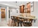 Nice home bar featuring a wet bar with seating and plenty of cabinet space for beverages and glassware at 27290 E Nova Cir, Aurora, CO 80016