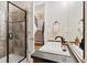 Bathroom with a tiled shower and a sink with a black countertop and black faucet at 27290 E Nova Cir, Aurora, CO 80016