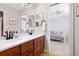 Bright bathroom features a double sink vanity with modern fixtures and a glimpse into an adjacent bedroom at 27290 E Nova Cir, Aurora, CO 80016