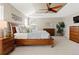Comfortable bedroom with a wooden bed frame, ceiling fan, and matching dressers at 27290 E Nova Cir, Aurora, CO 80016