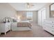 Neutral bedroom featuring large bed with neutral bedding and throw pillows, carpeted floors, and a large window at 27290 E Nova Cir, Aurora, CO 80016